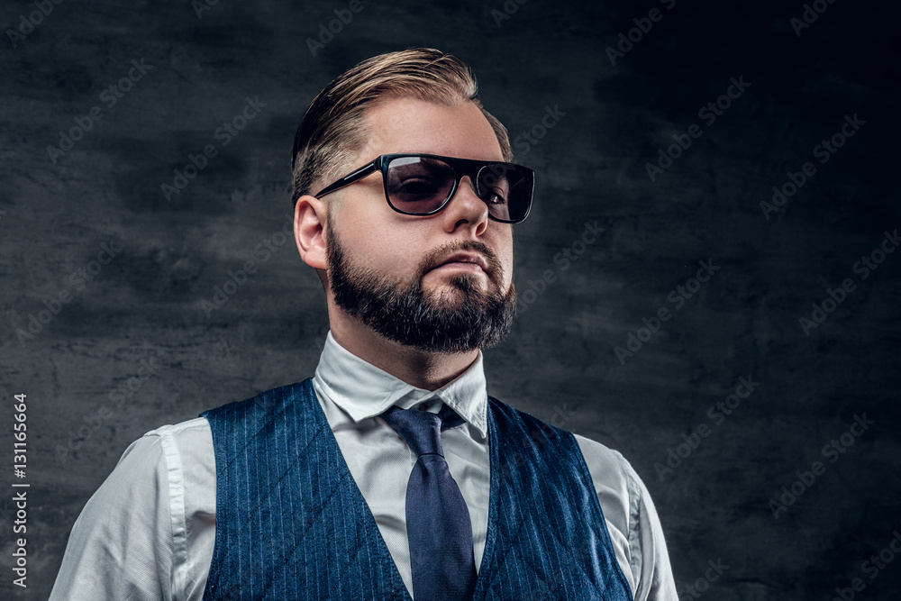 Fototapeta premium Bearded male in sunglasses wearing waistcoat and bow tie.