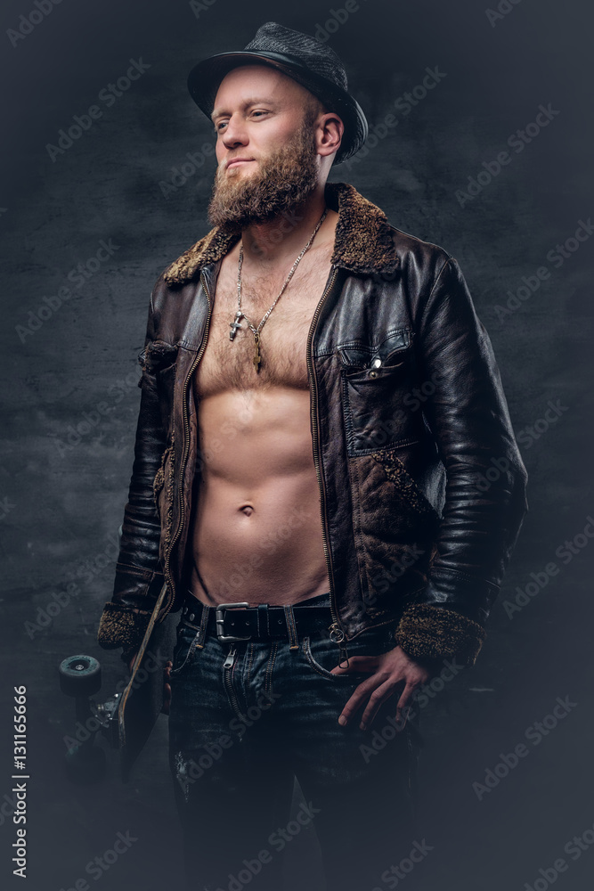 Bearded man wearing a leather jacket on naked torso.