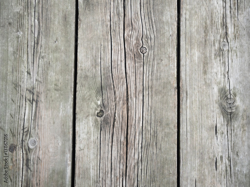 Background of a gray wooden wall surface. Gray texture close up. Abstract wooden wall pattern of the old surface. Old wooden fence texture close up.