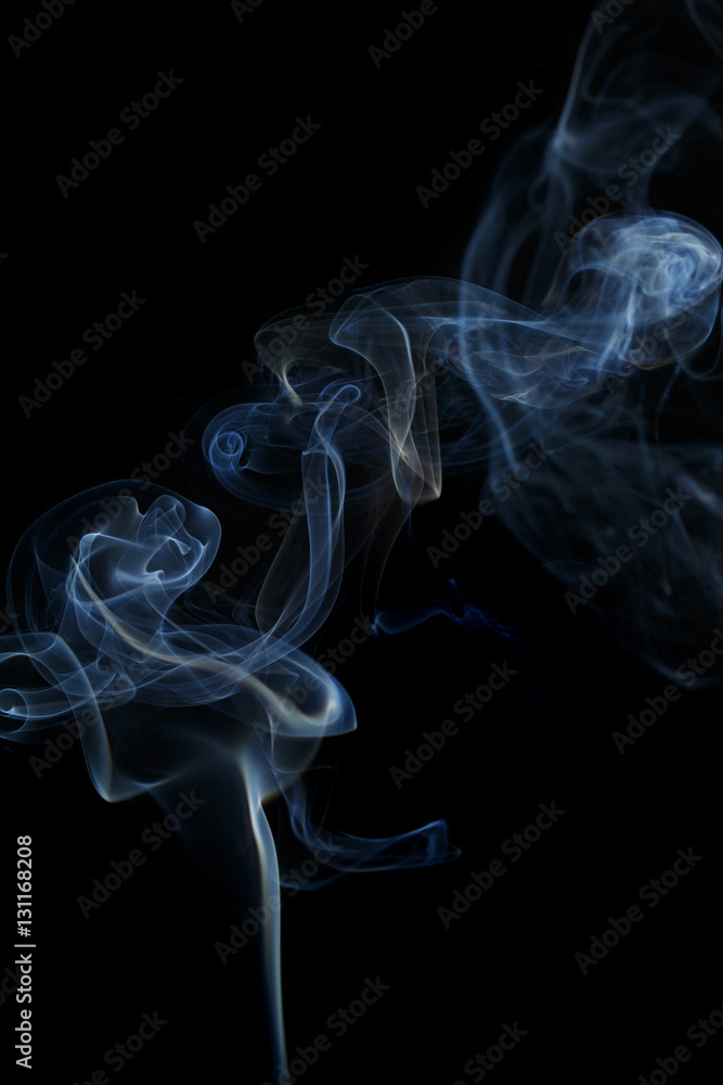 Abstract art. Color white blue smoke from the aromatic sticks on a black background. Background for Halloween. Texture fog. Design element. The concept of aromatherapy. Abstract art. Color white blue smoke from the aromatic sticks on a black background. Background for Halloween. Texture fog. Design element. The concept of aromatherapy.