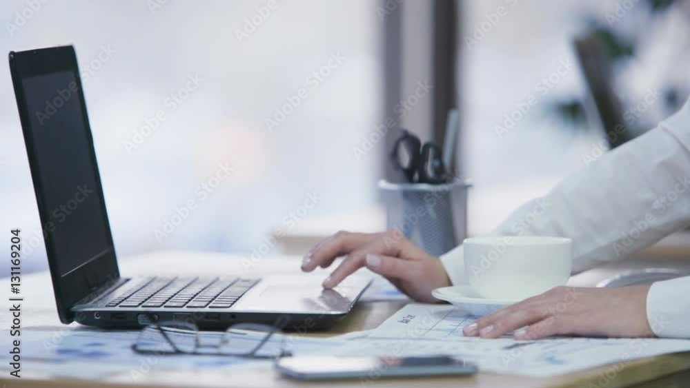 Female secretary having a break, surfing net and drinking coffee at workplace Female secretary having a break, surfing net and drinking coffee at workplace