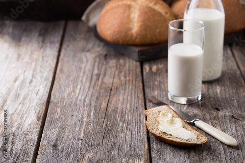 Rustic breakfast with wholegrain bread, milk and butter