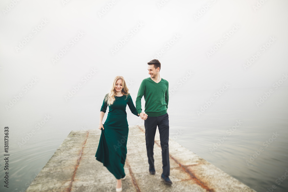 Lovely couple kissing and hugging on a sea dock Lovely couple kissing and hugging on a sea dock
