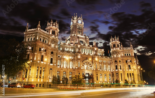 Cybele Palace at the Plaza de Cibeles with light trails of the traffic night, Madrid, Spain