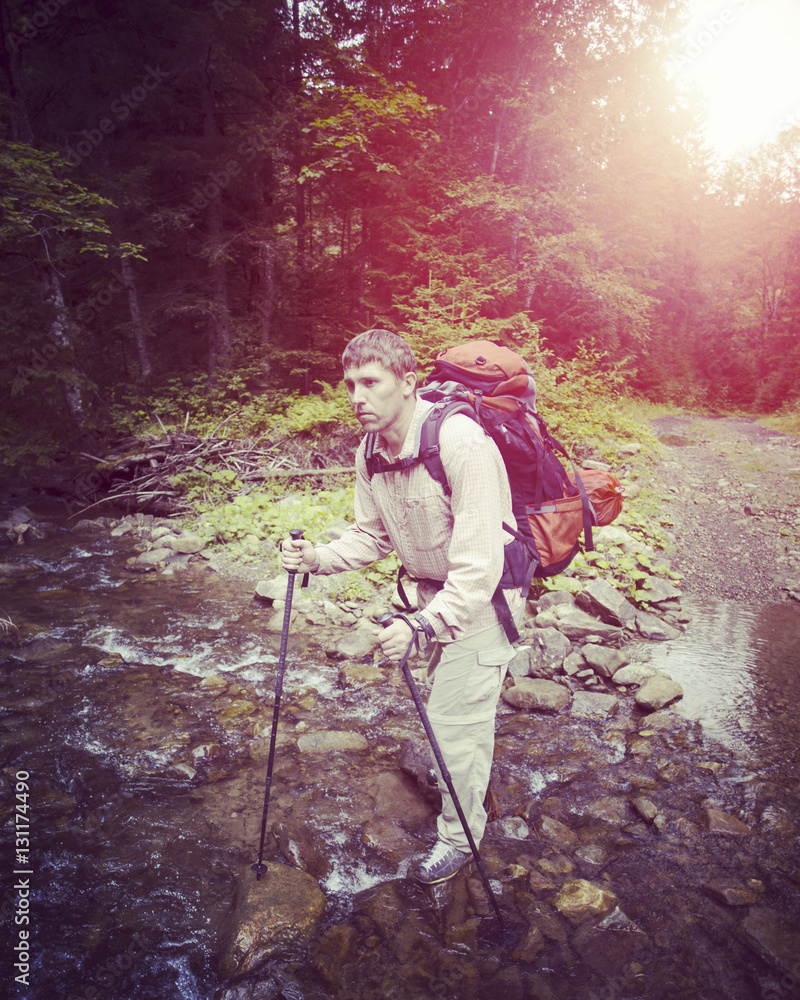 Man tourist walking the mountains with a backpack. Man tourist walking the mountains with a backpack.