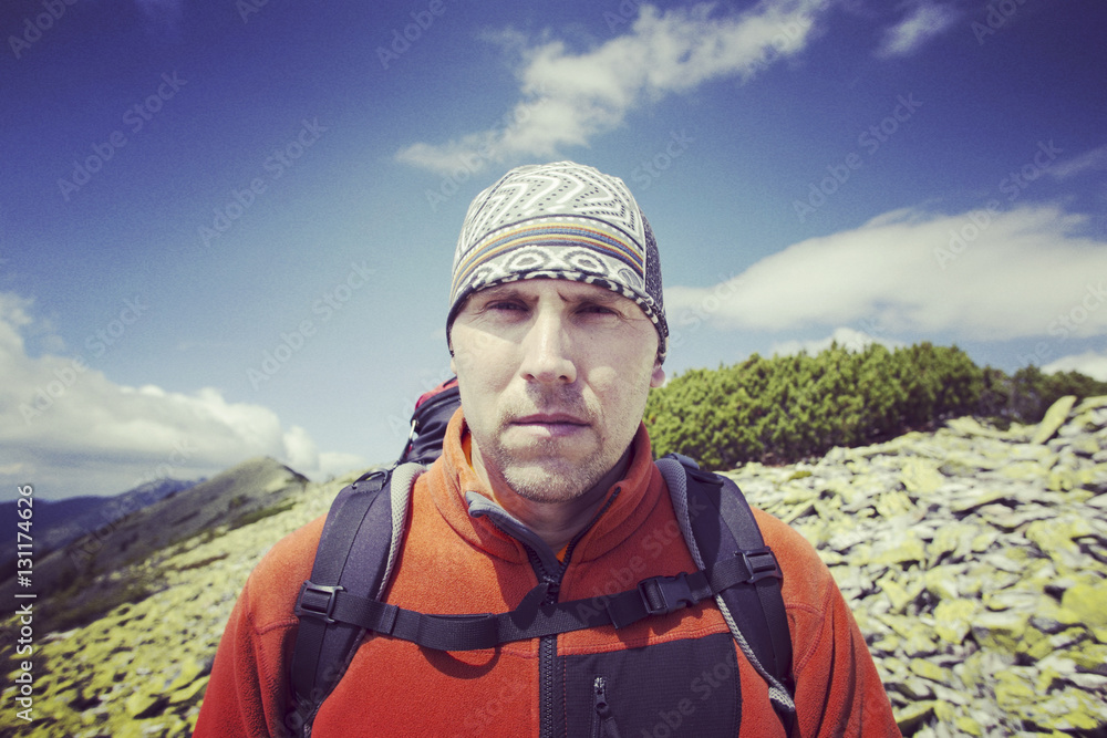Man tourist walking the mountains with a backpack. Man tourist walking the mountains with a backpack.