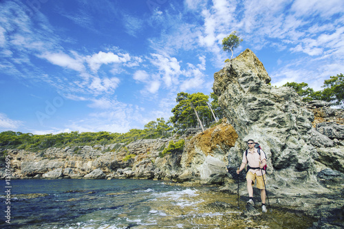 Man tourist walking the mountains with a backpack.