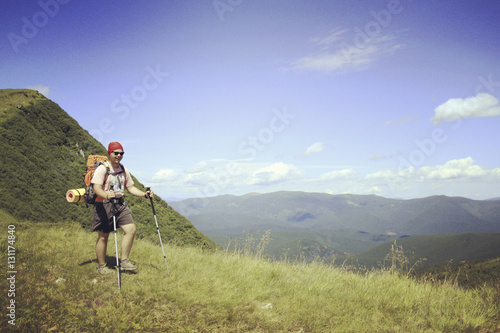 Man tourist walking the mountains with a backpack.