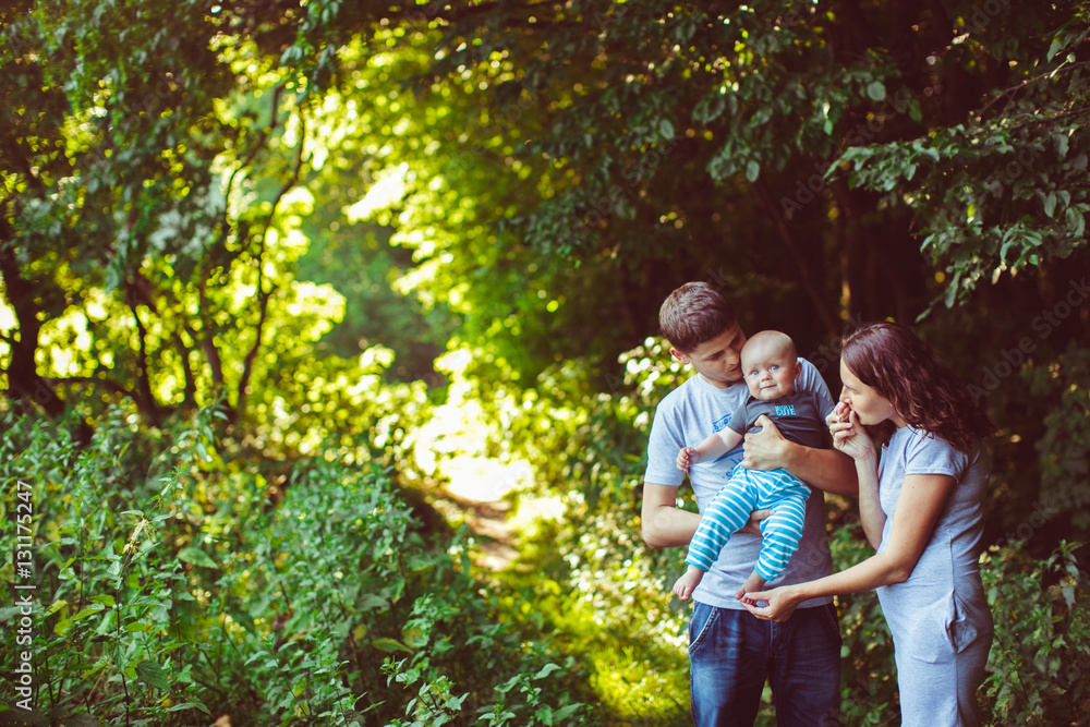 Fototapeta premium The mother and father embracing their son