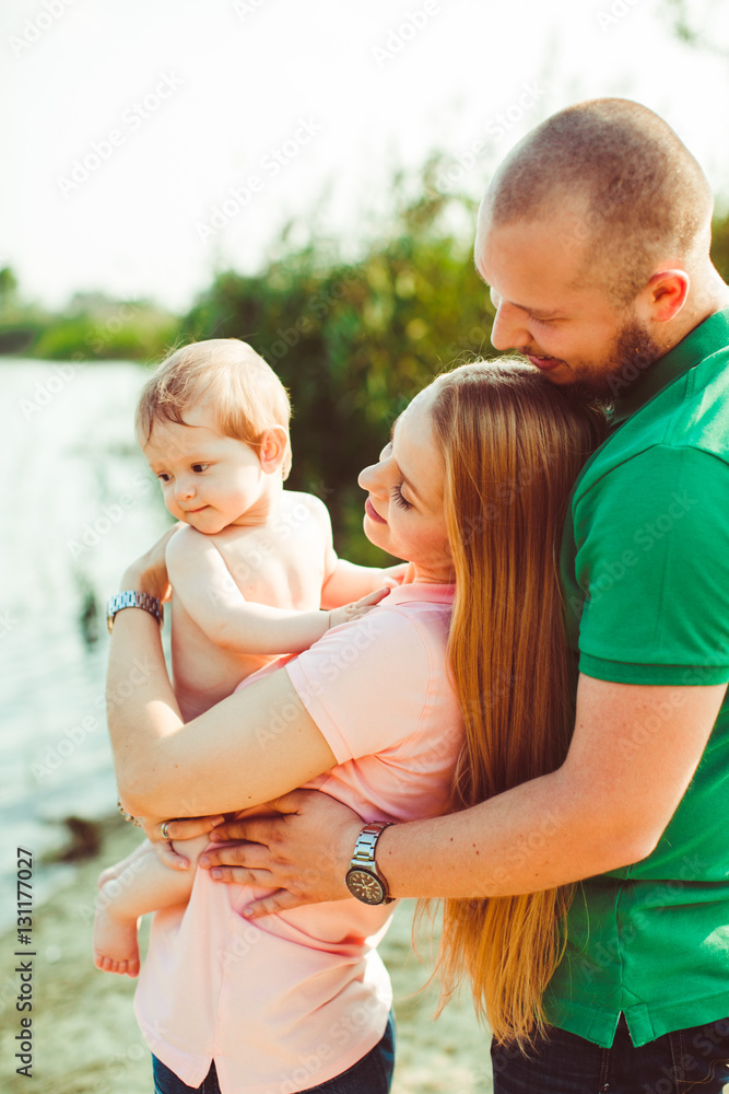 Fototapeta premium The mother,father and son stand near lake