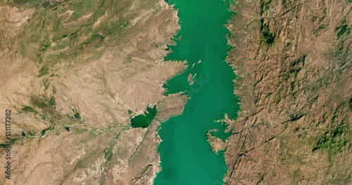 High-altitude overflight aerial of Cahora Bassa lake, Tete Province, Mozambique. Clip loops and is reversible. Elements of this image furnished by USGS/NASA Landsat