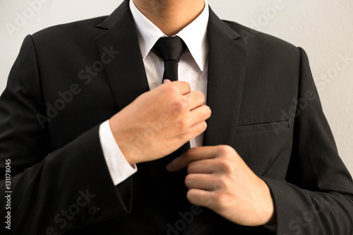 Businessman in black suit with  black necktie