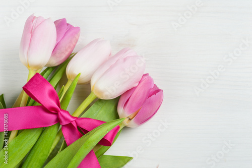 Red pink tulips with red ribbon