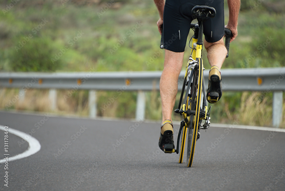 Naklejka premium Active senior with bicycle,cyclist on road bike