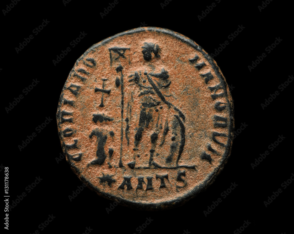 Ancient roman copper coin with person image on it isolated on black Ancient roman copper coin with person image on it isolated on black