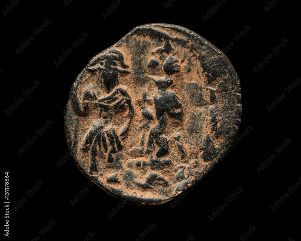 Ancient copper Byzantine coin isolated on black Ancient copper Byzantine coin isolated on black