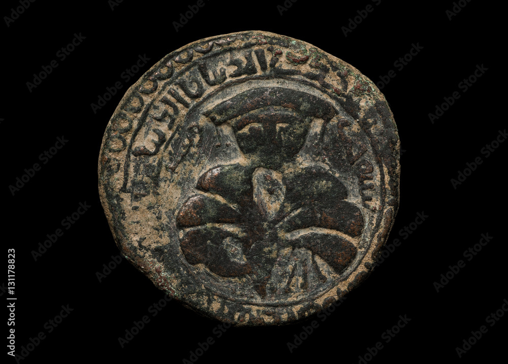 Ancient islamic copper coin isolated on black Ancient islamic copper coin isolated on black