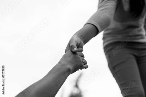 Help Concept Young girl Hands reaching out to help old woman