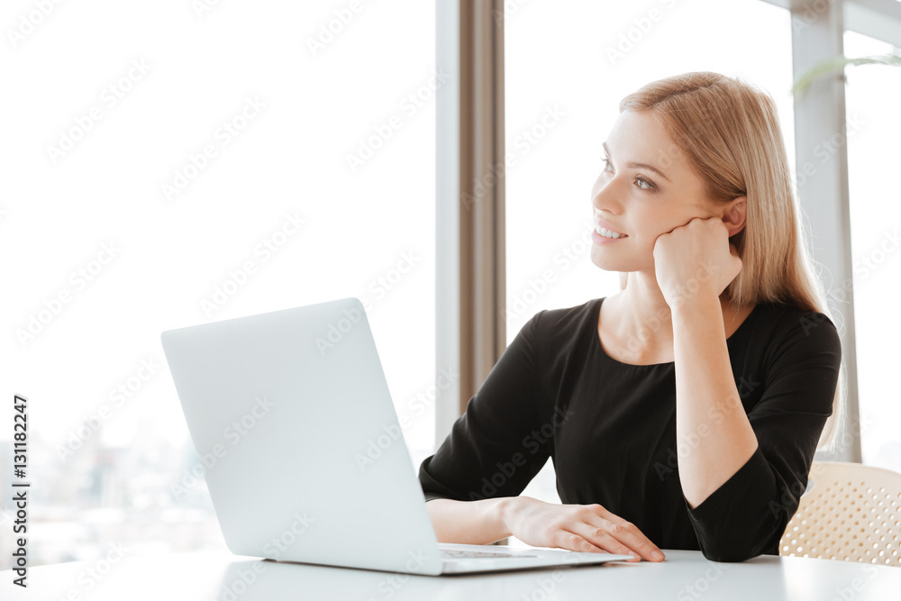 Thoughtful young lady worker using laptop computer Thoughtful young lady worker using laptop computer