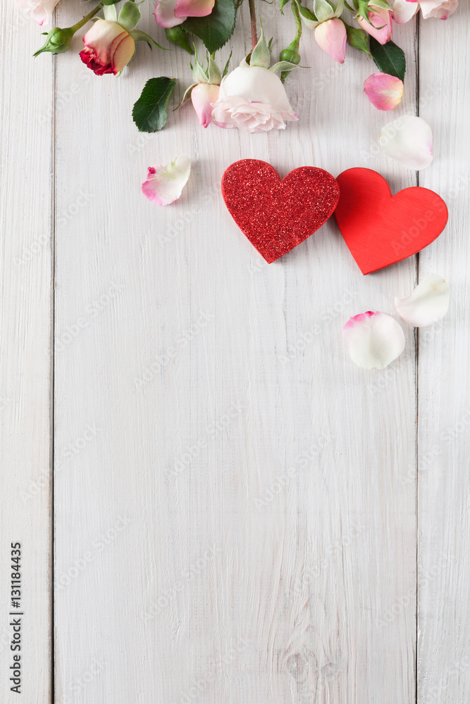 Fototapeta premium Valentine day background, hearts and flowers on white wood