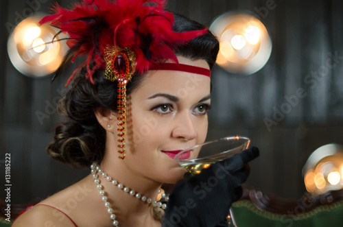 Middle aged beautiful women in Greate Gatsby style with glass of