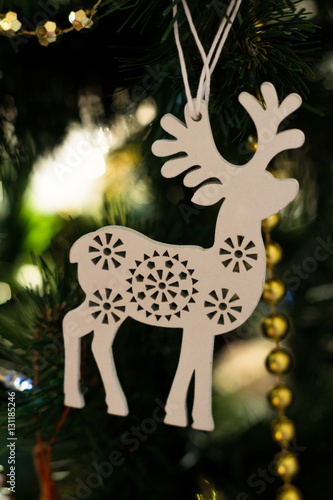 wooden toy deer on white Christmas tree