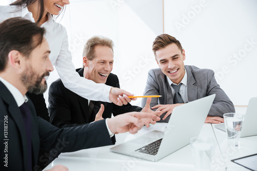Happy Business team looking at laptop