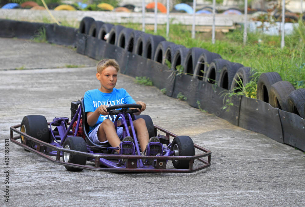 boy is driving a kart on circuit boy is driving a kart on circuit