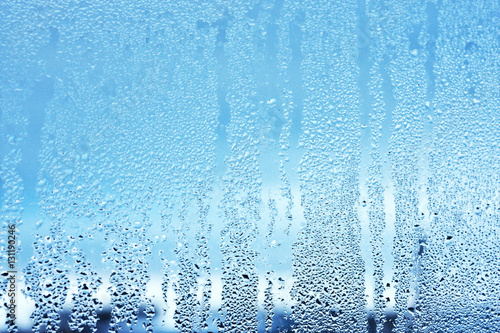Window glass in the condensate in the cold currents of the water drops background