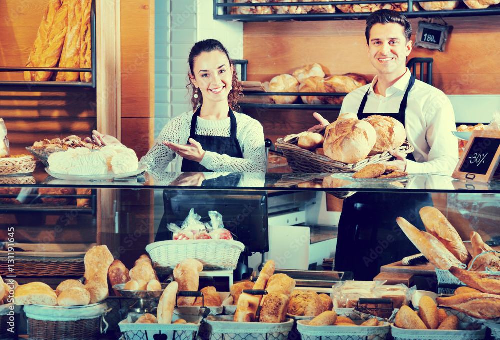 Portrait of charming happy smiling couple at bakery display