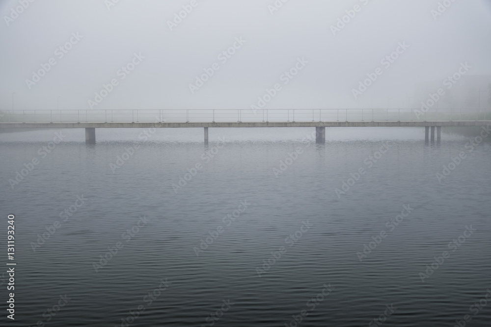 Bridge in calm peaceful misty weather in white dreamy landscape Bridge in calm peaceful misty weather in white dreamy landscape