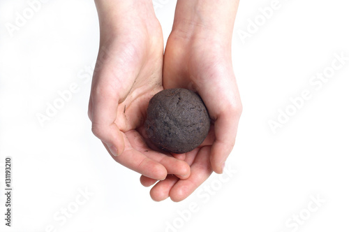 Clayey soil - test ball in hands on white background