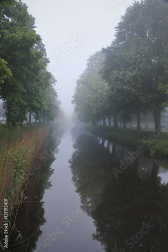 Mist covering the city channel in Breda giving mysterious white and grey landscape