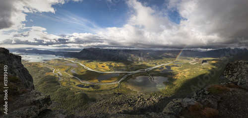 Big panorama from Skierfe top mountain over viewing rapadalen river valley beautiful autumn coloration and rainbow