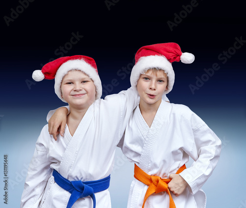 Boys in caps of Santa Claus on a gradient background