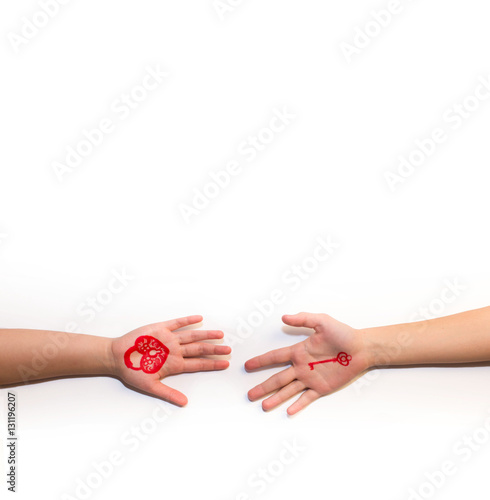 Heart and key are drawn on hands on white background