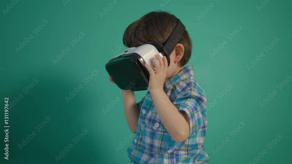 Little boy using virtual reality device over green wall Little boy using virtual reality device over green wall