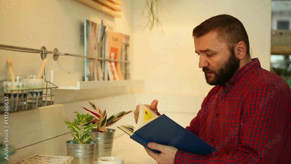 Man in the cafe and reading book, close Man in the cafe and reading book, close