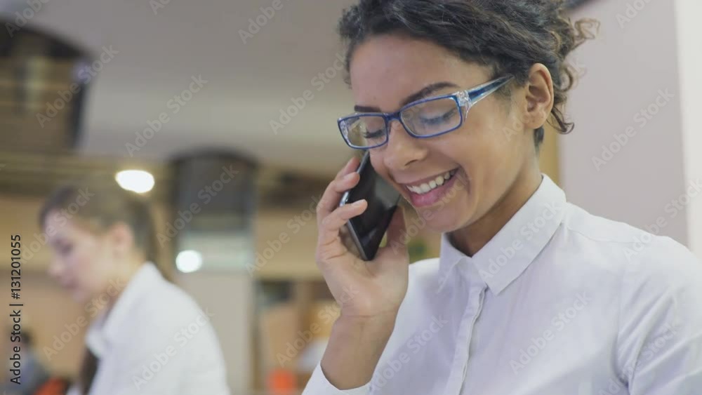 Beautiful female office worker in eyeglasses talking on the phone, personal call Beautiful female office worker in eyeglasses talking on the phone, personal call