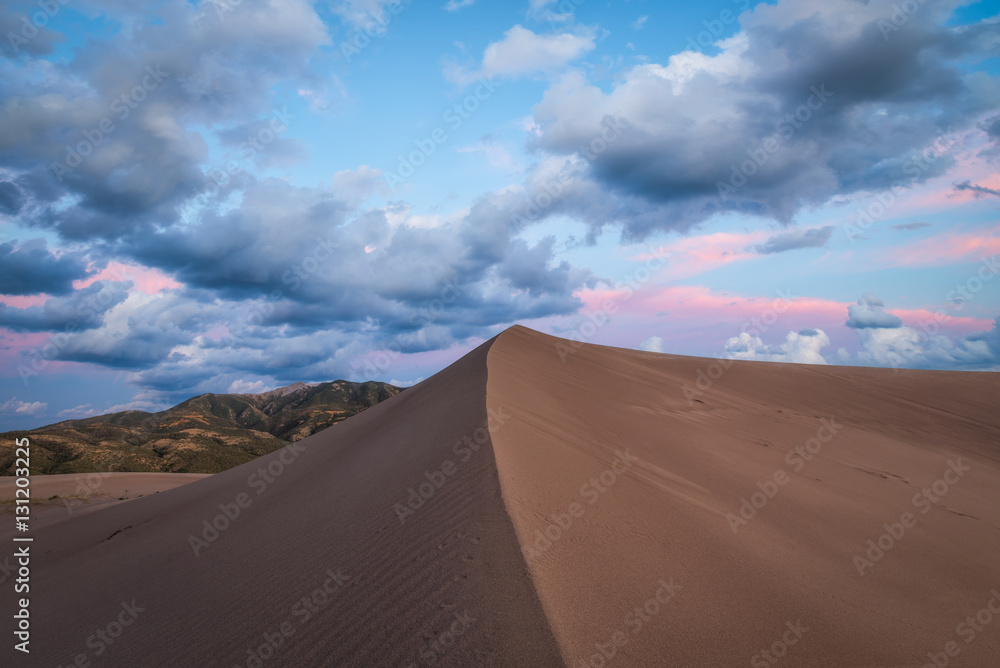 Untouched Sand Dune during a cloudy sunset 