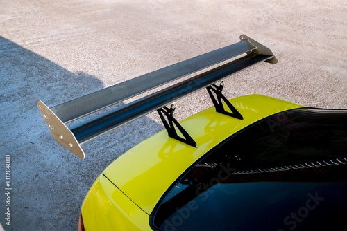 Fényképezés car part ; Close up detail of a custom racing carbon fiber spoiler on the rear o