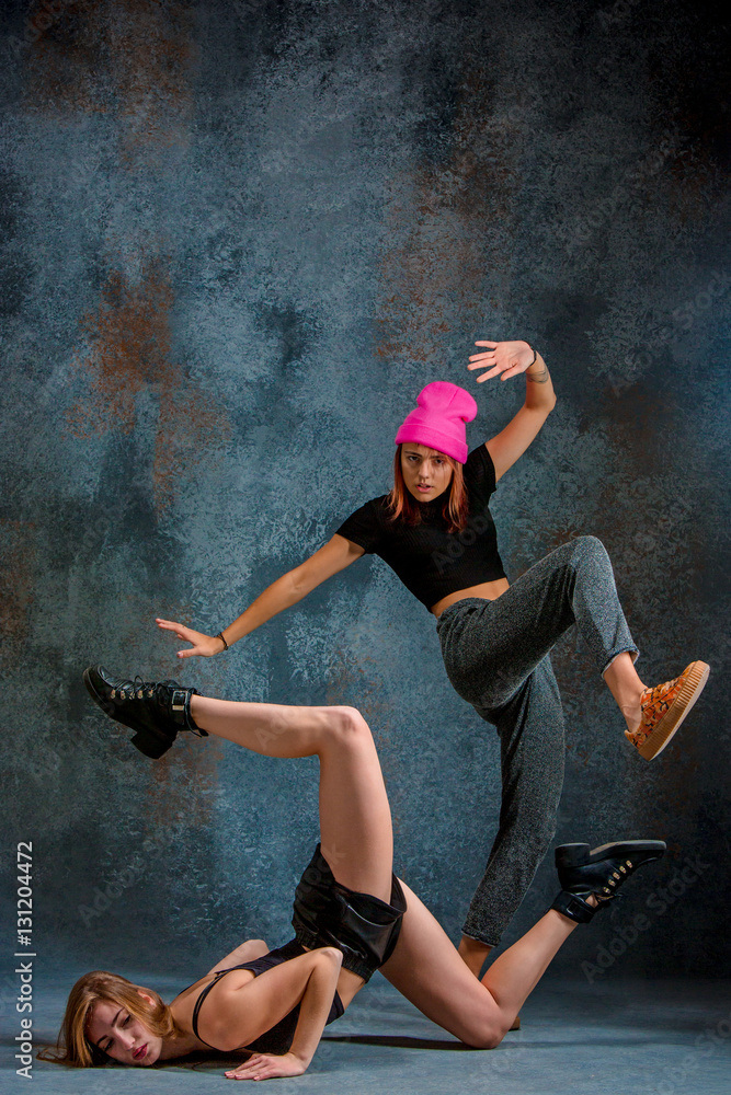 The two attractive girls dancing twerk in the studio