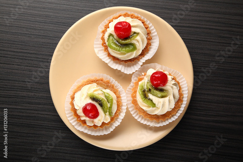 cake with cream  cake with cream  garnished with a slice of kiwi and cherry