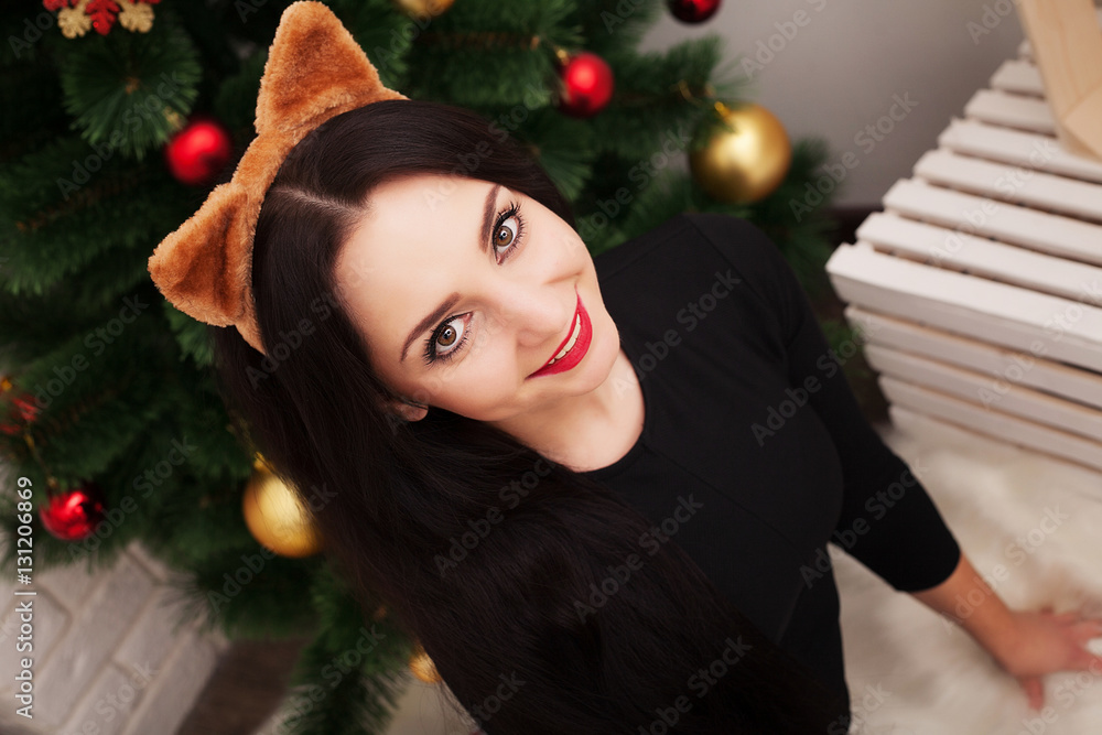 people, holidays and glamour concept - smiling woman in evening dress over christmas tree people, holidays and glamour concept - smiling woman in evening dress over christmas tree