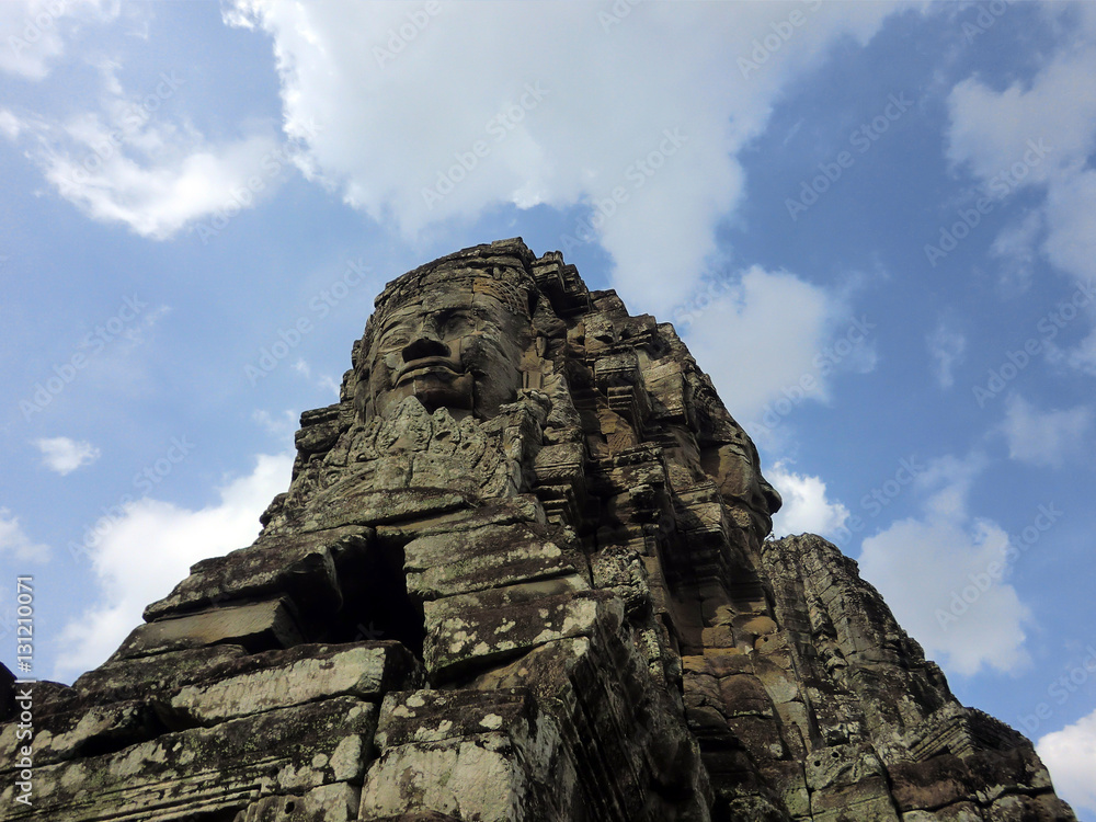 Fototapeta premium Bayon temple with carved stone faces in Siem Reap Cambodia jungle