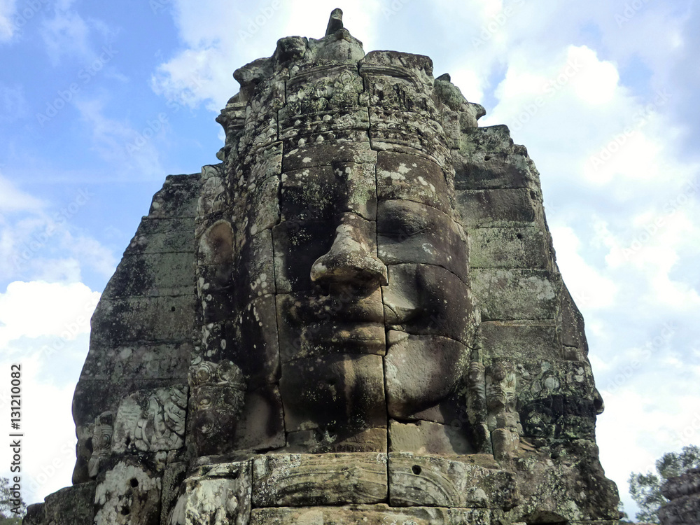 Bayon temple with carved stone faces in Siem Reap Cambodia jungle