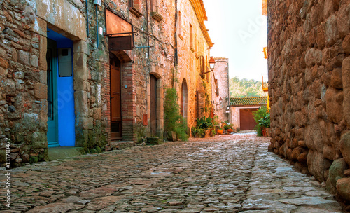 A street in the old town of Peratallada  Catalonia  Spain. Medieval street in the mediaval town in Europe.  Panoramic view of old town  in beautiful evening light at sunset 