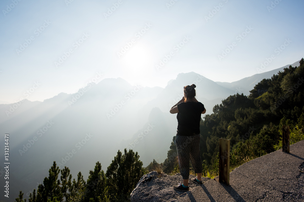 Rear view of woman looking at view of mountains, Passo Maniva, Italy Rear view of woman looking at view of mountains, Passo Maniva, Italy