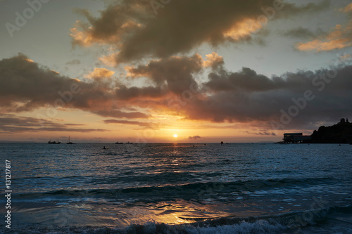 Silhouette of boats on sea at sunrise, Tenby, Pembrokeshire, Wales photo