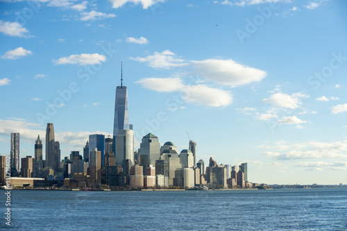 Blue sky view of the Downtown Manhattan New York City skyline from across the Hudson River in New Jersey